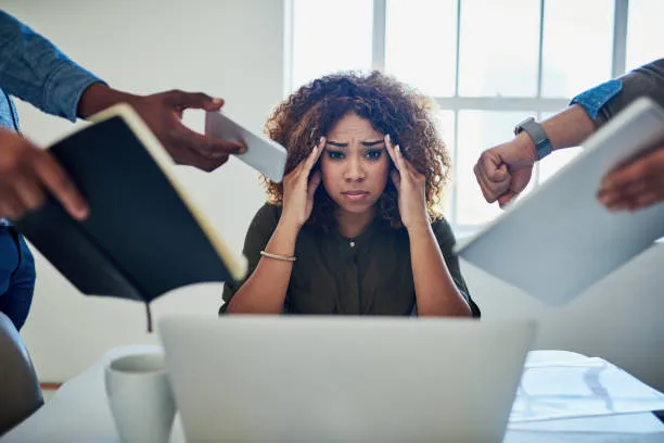 Stressed woman pressing her hands to her head and having a bunch of people hand her items